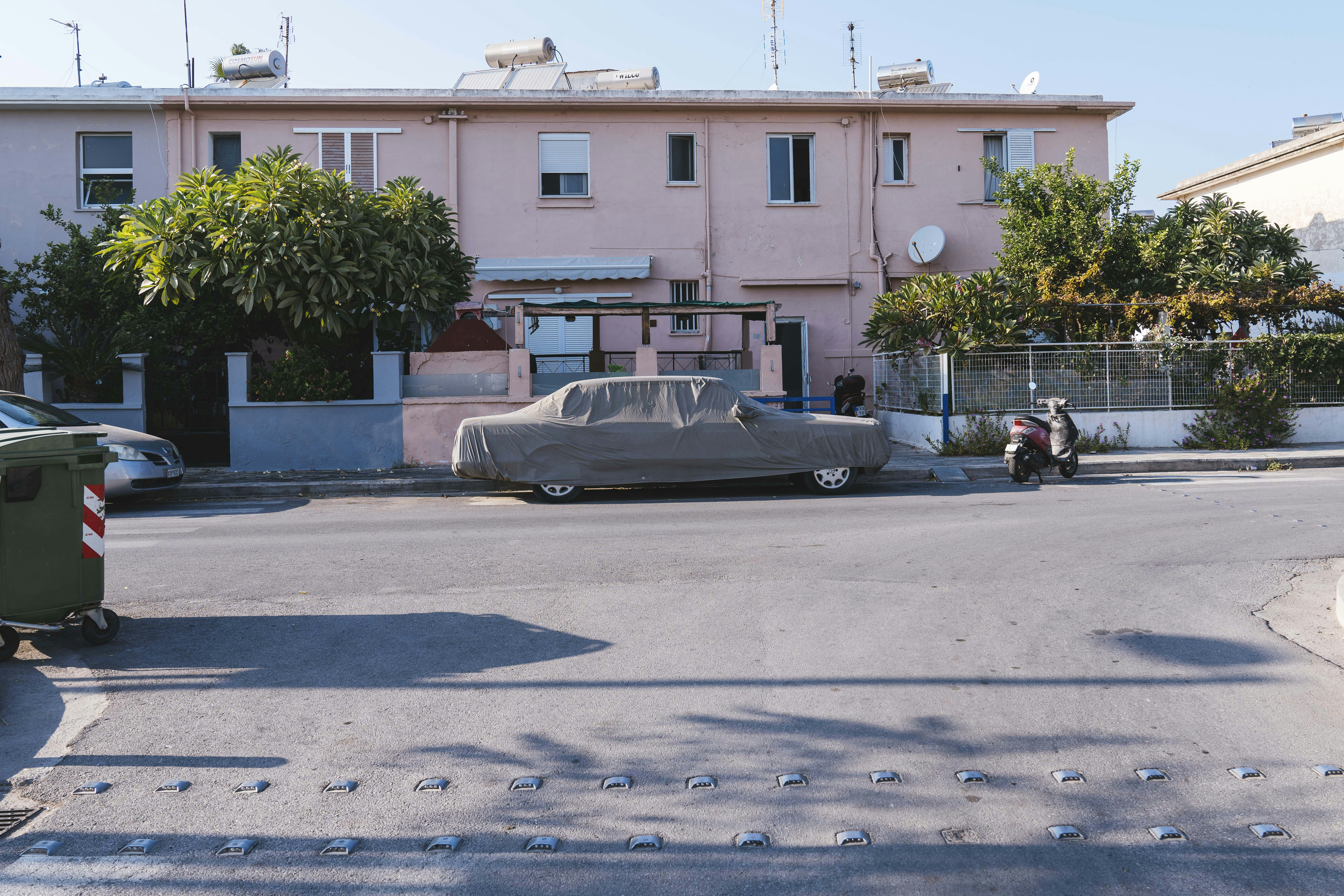 brown car parking near gate