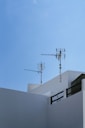two brown antenna on concrete building