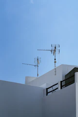 Sleek digital antenna mounted on a clean balcony with a futuristic blue and white color palette.
