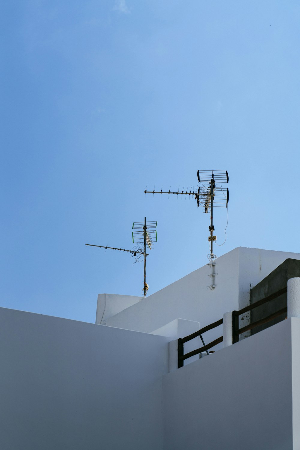 two brown antenna on concrete building