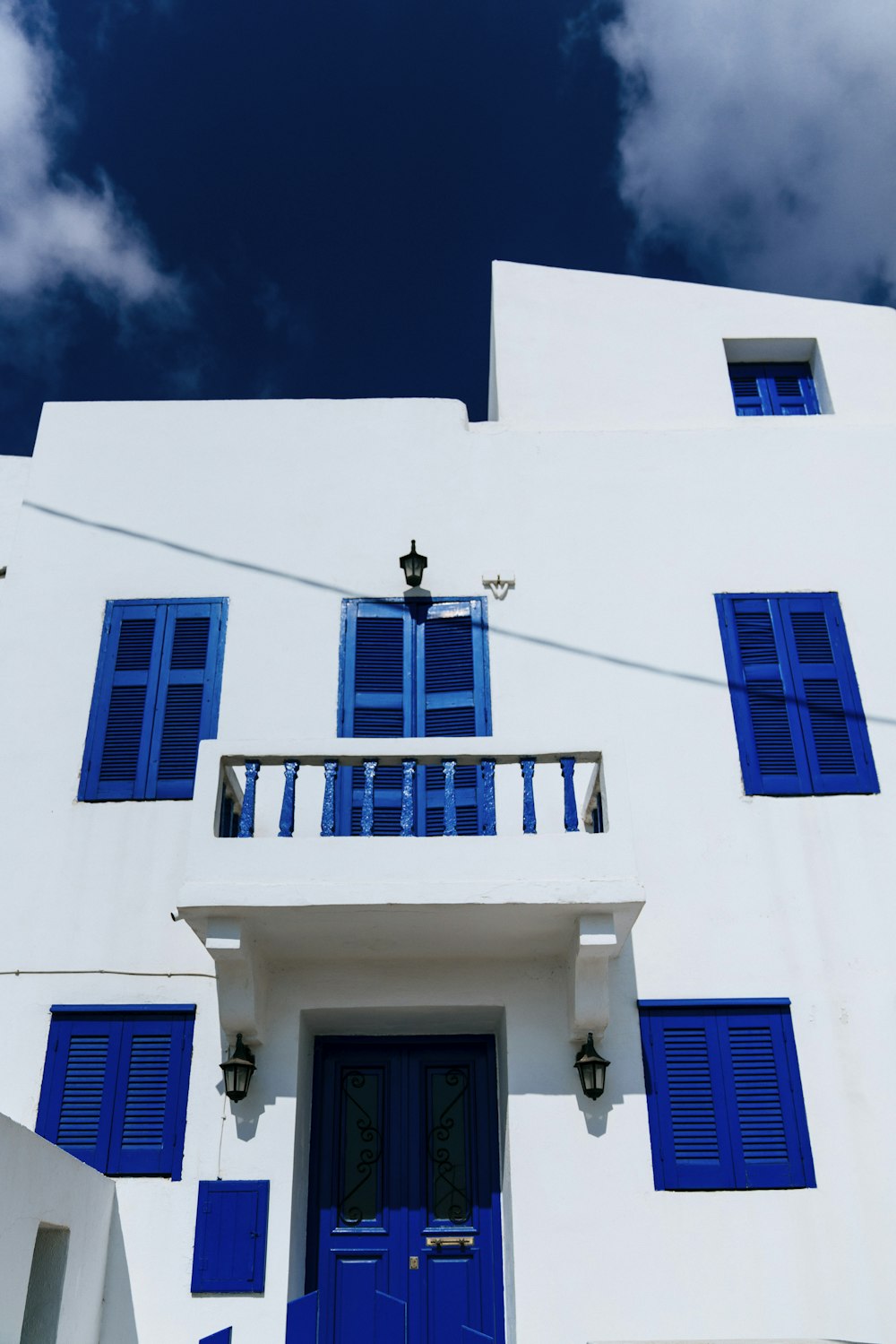 blue painted windows and doors white concrete building