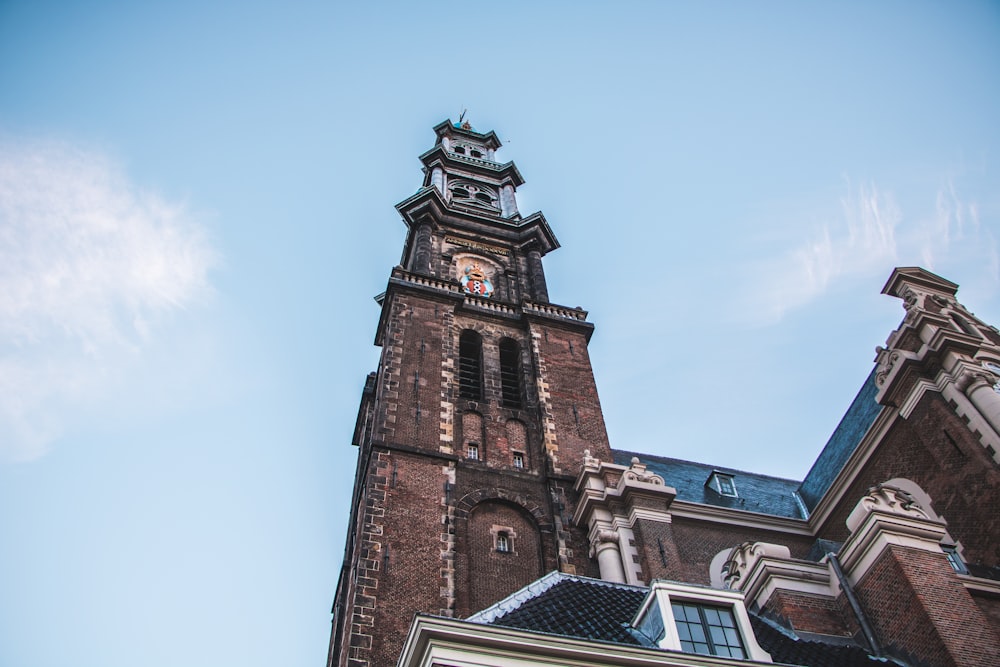 low angle photography of brown building blue sky