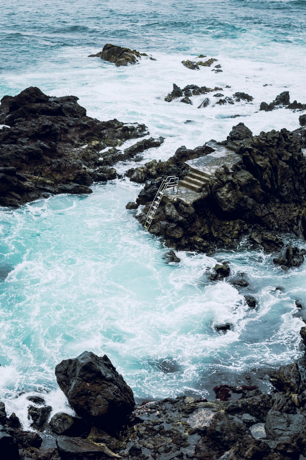 stairs on gray rock near ocean