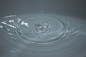 A close-up of a water droplet on a smooth surface.