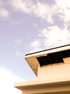 A commercial building with a newly installed flat roof under a clear sky