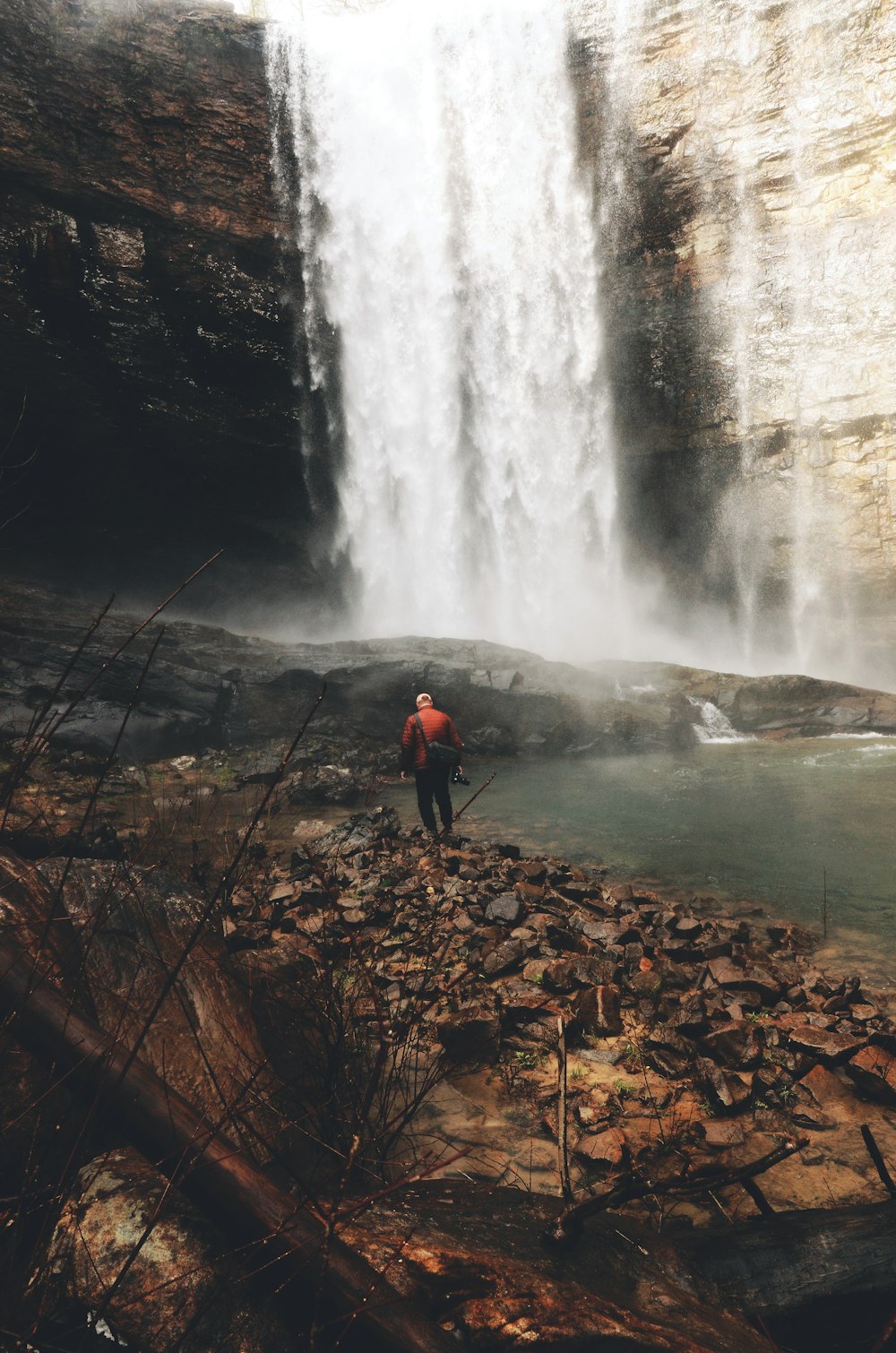 man near waterfall