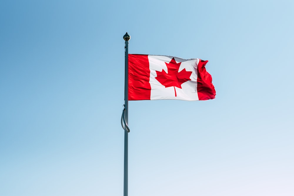 Canada flag on pole during daytime