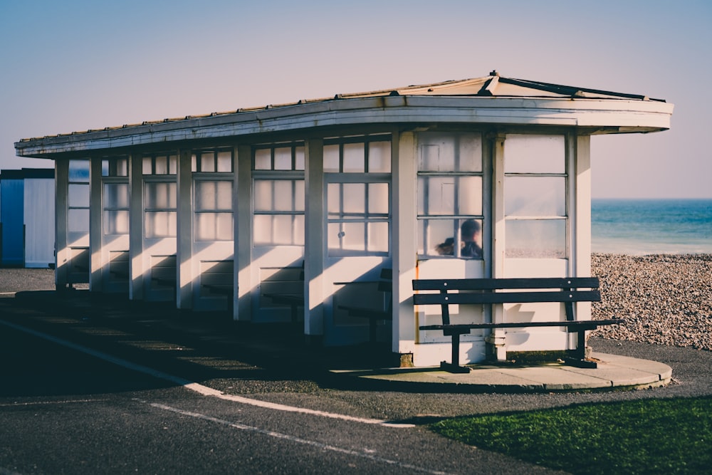 a small white building sitting on the side of a road