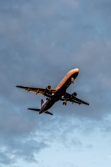 A commercial airplane taking off at sunrise.