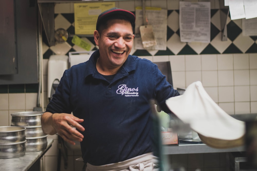 man making dough while smiling