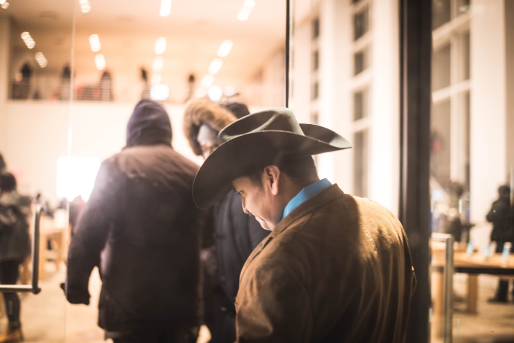 man wearing black cowboy hat