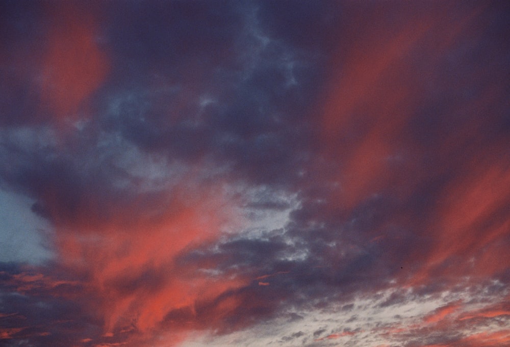 a plane is flying in the sky at sunset