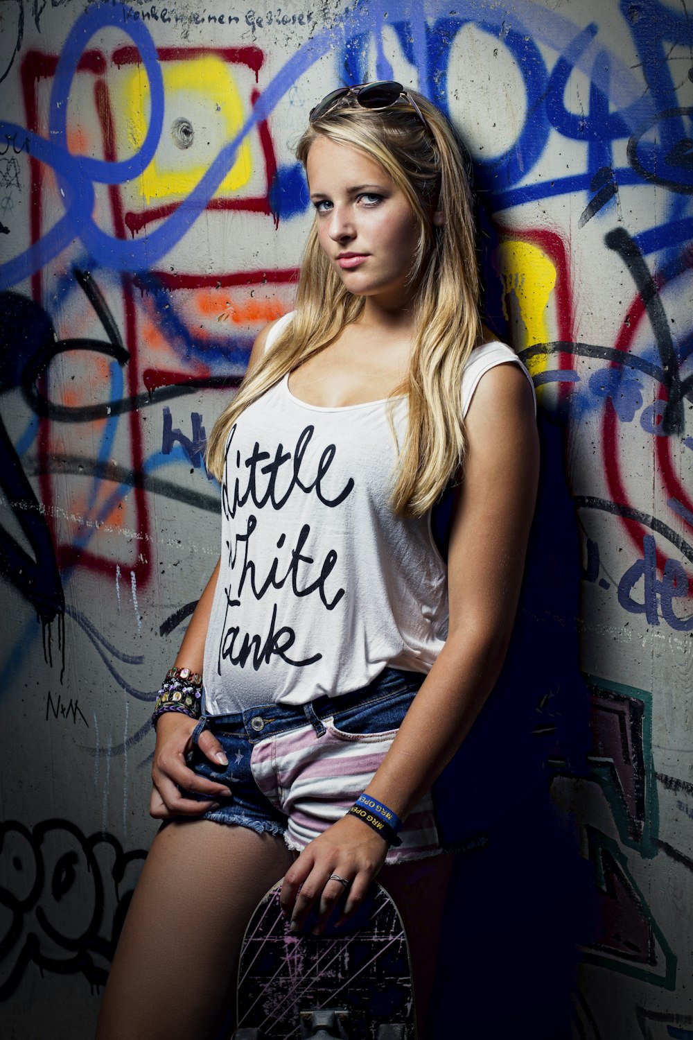 woman leaning on multicolored wall