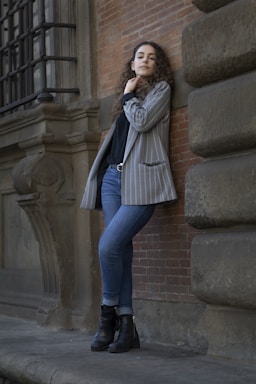 photography poses for women,how to photograph international women’s day; woman leaning against wall