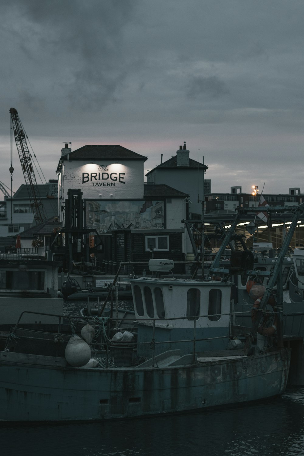 black and white houses near boat beside body of water