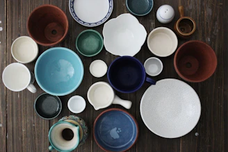 flatlay photo of ceramic mugs and bowls
