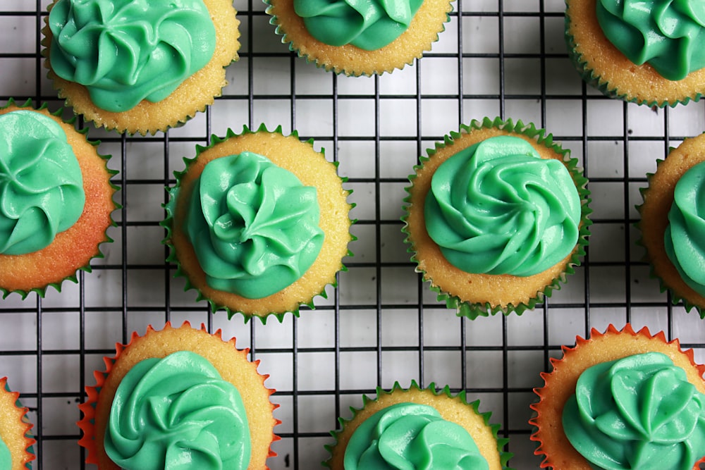 green cupcakes on black and white lined mat