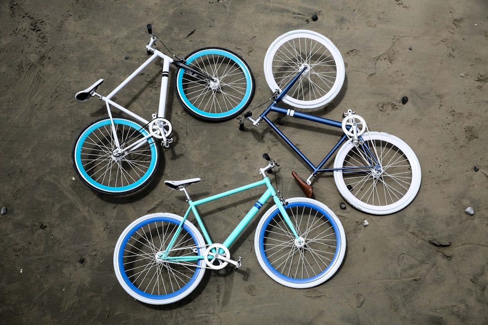 three road bikes on gray pavement