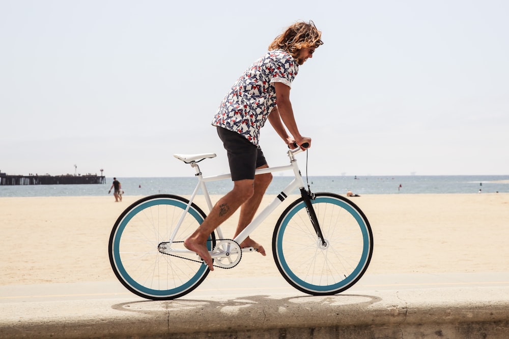 man cycling on pavement during daytime