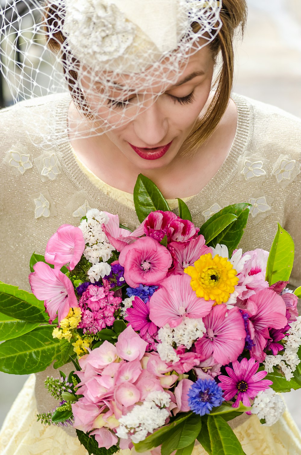 woman holding assorted-color flower bouquet