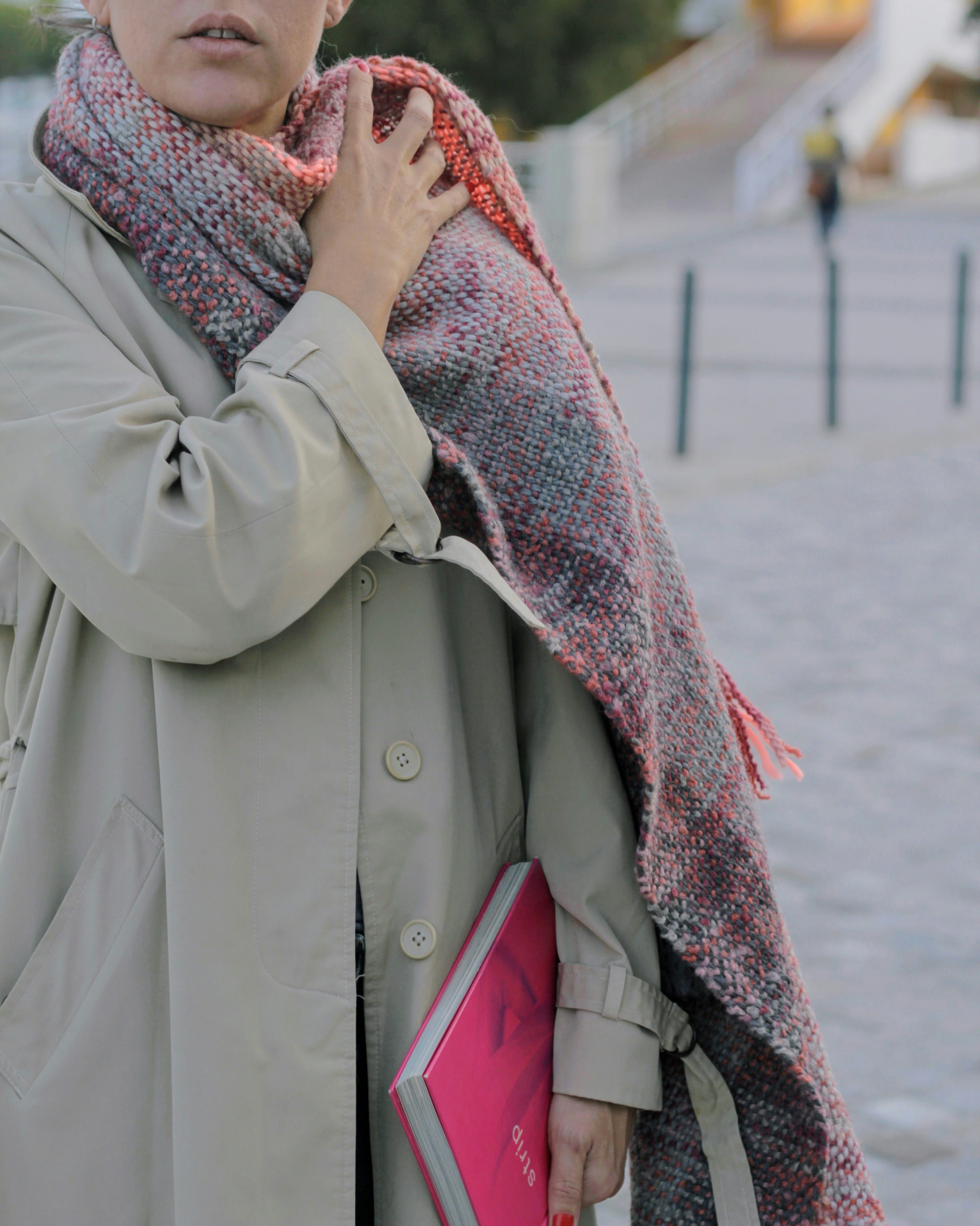 Woman in winter attire shopping with a stylish coat and scarf