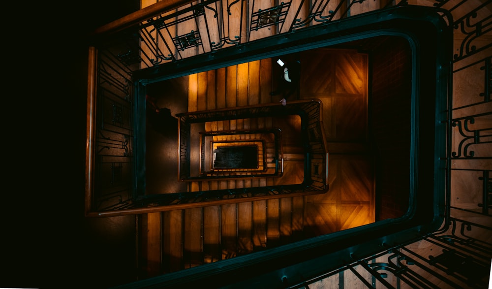 aerial photography of brown and green spiral stairs