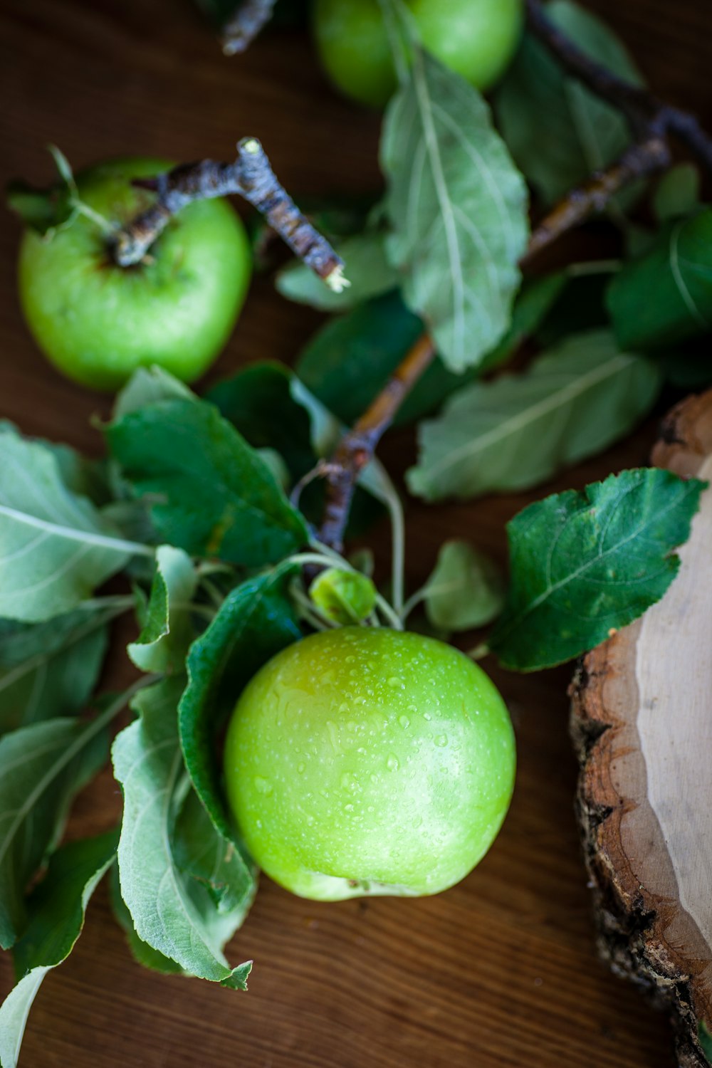 view of three green apples on table