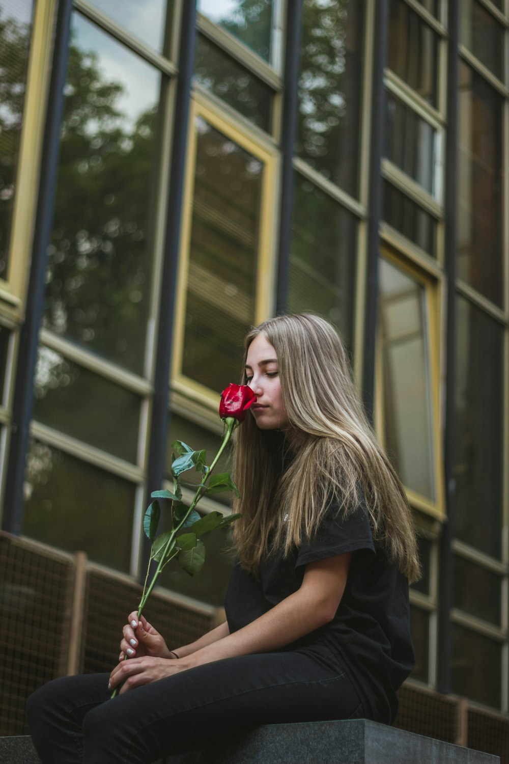 woman smells red rose