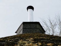 Close-up of soot and debris being cleaned from inside a chimney flue.