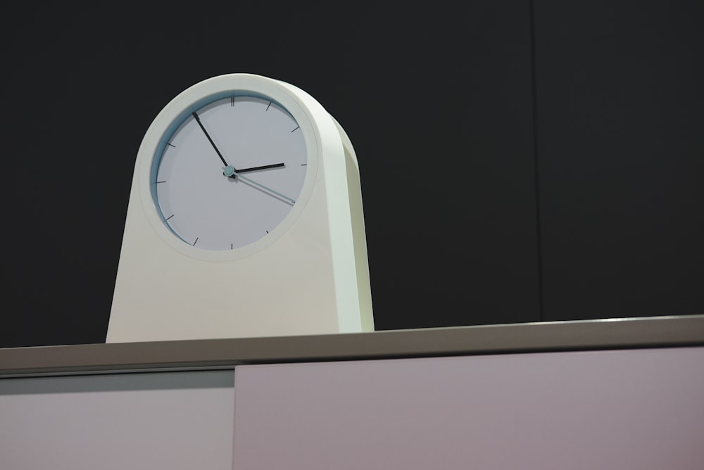 arched white analog clock