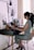A young woman wearing a stylish bracelet while working at a desk.