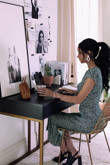 Portrait of Véronique Pezard working at her desk in a cozy office with blue and gold accents.