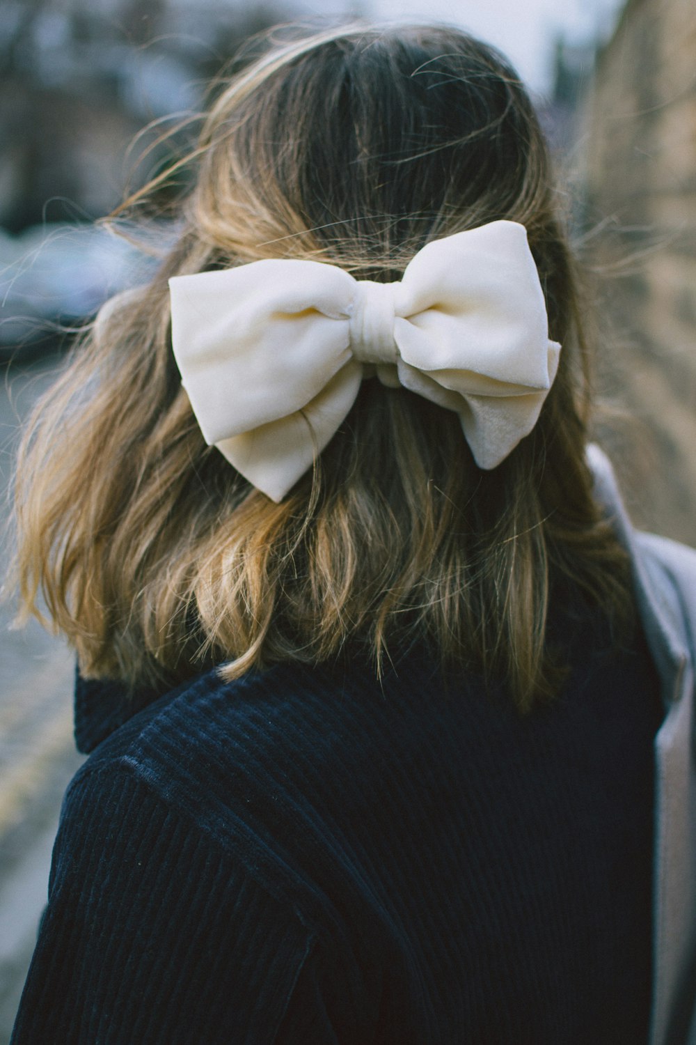 woman wearing white ribbon tie
