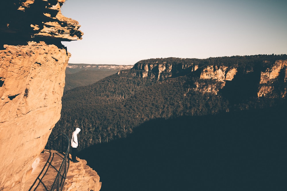 man standing on mountain edge