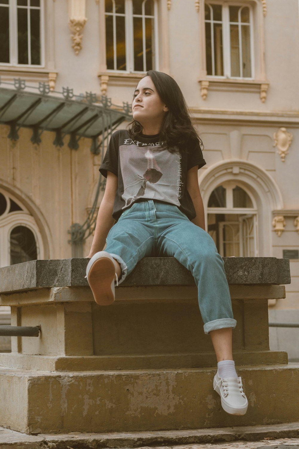 woman sitting on concrete