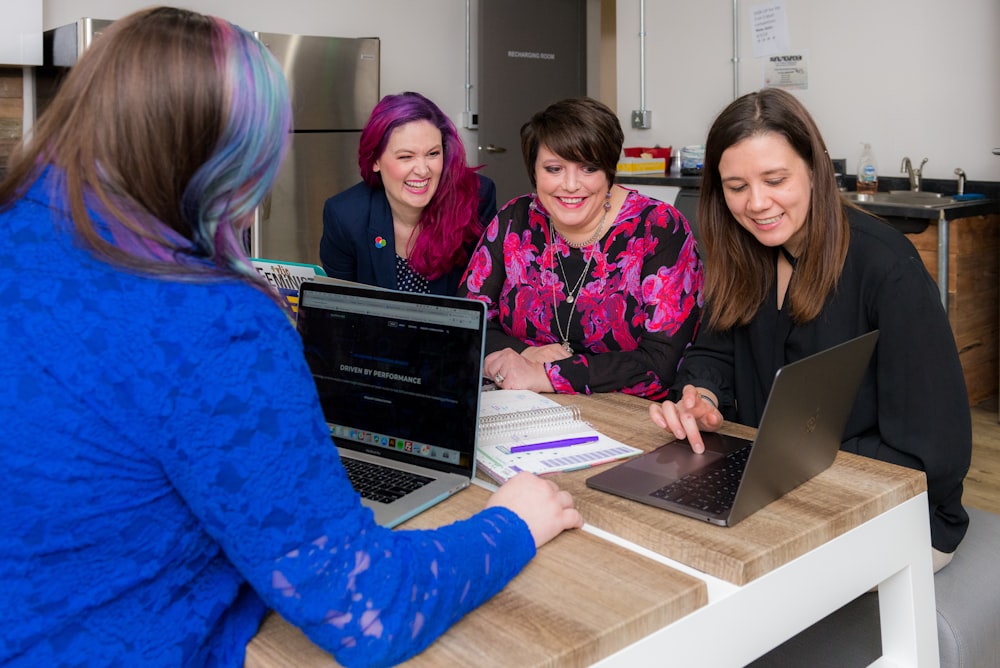 woman waering blue cardigan using laptop