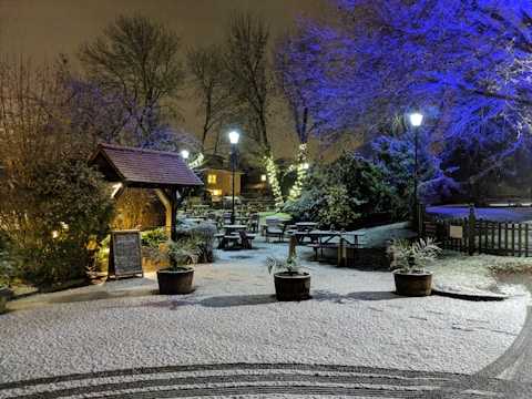 An outdoor event space adorned with snowflake decorations and illuminated winter props creating a magical atmosphere.