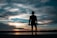 silhouette of man standing holding camera