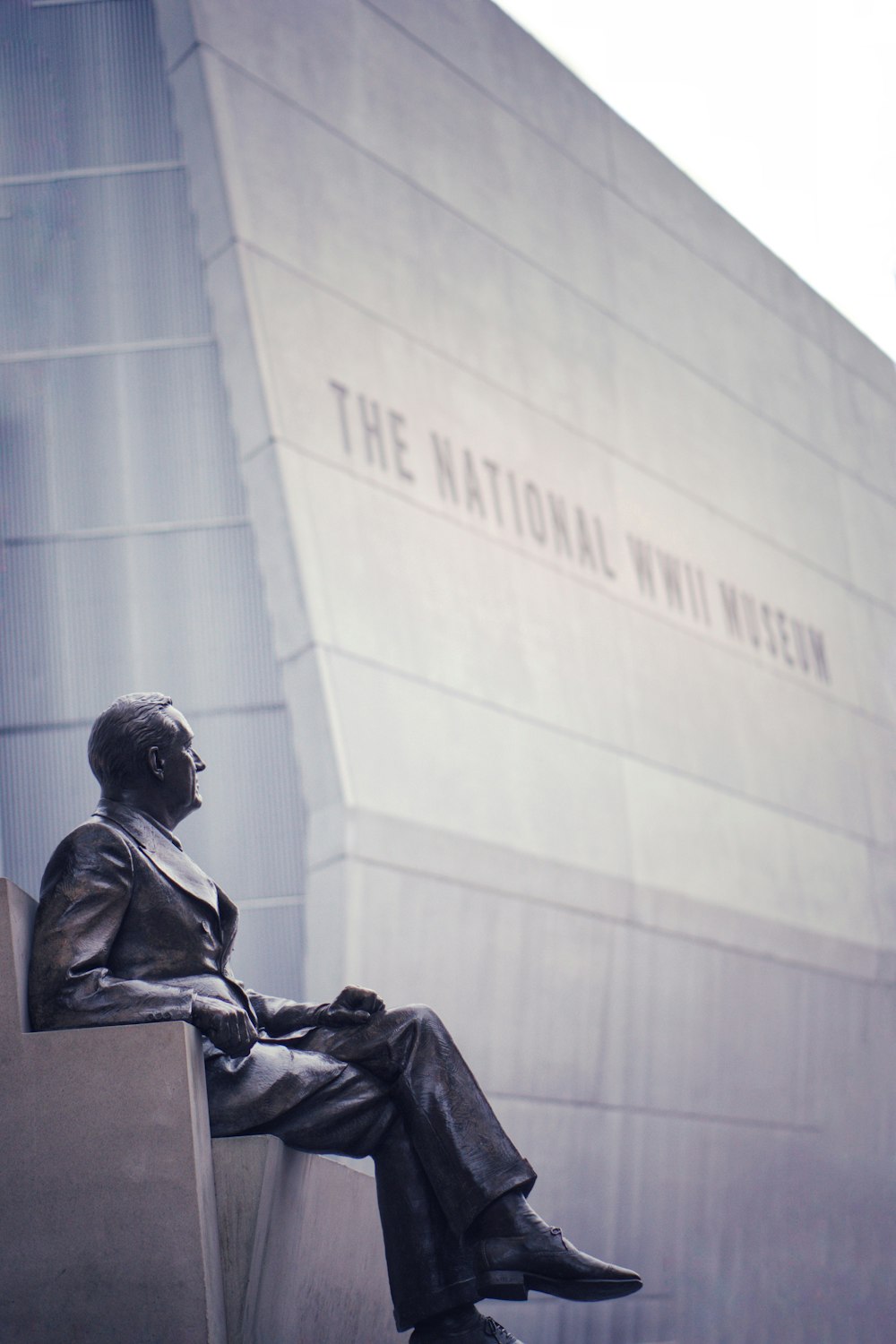 man sitting down statue