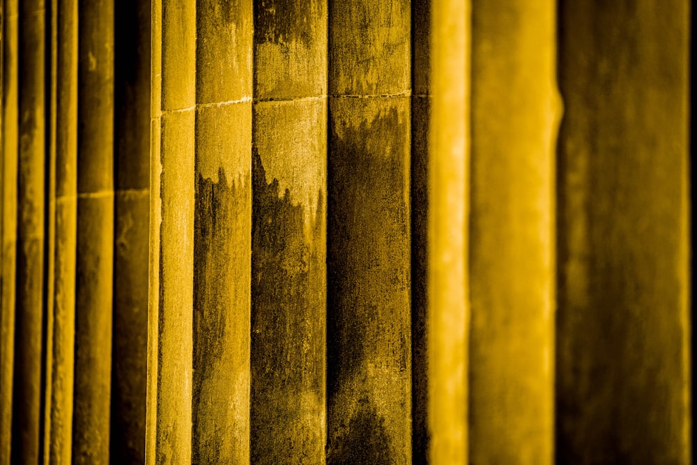 a close up of a wall with yellow paint