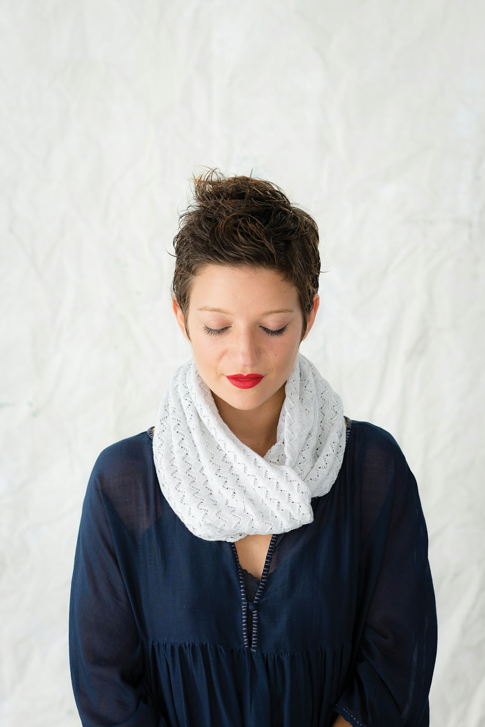 woman standing beside white textile