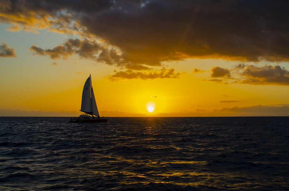 black sailboat on body of water