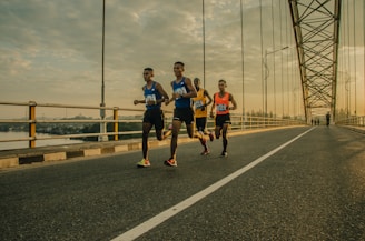 four men running on asphalt floor