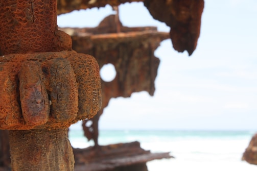 Close-up of stacked rusty ship metal sheets ready for trade.