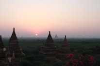 A peaceful prayer area set up in a luxury hotel room overlooking Hanoi’s skyline at sunset.