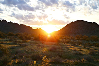 Sunrise casting warm light over the rugged peaks of Saint Catherine mountain, with soft desert hues and a clear sky.