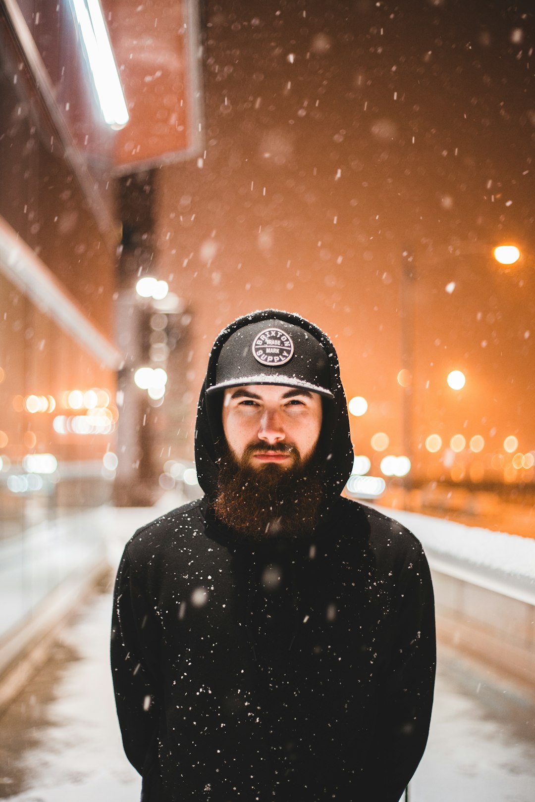 man wearing hoodie during snow