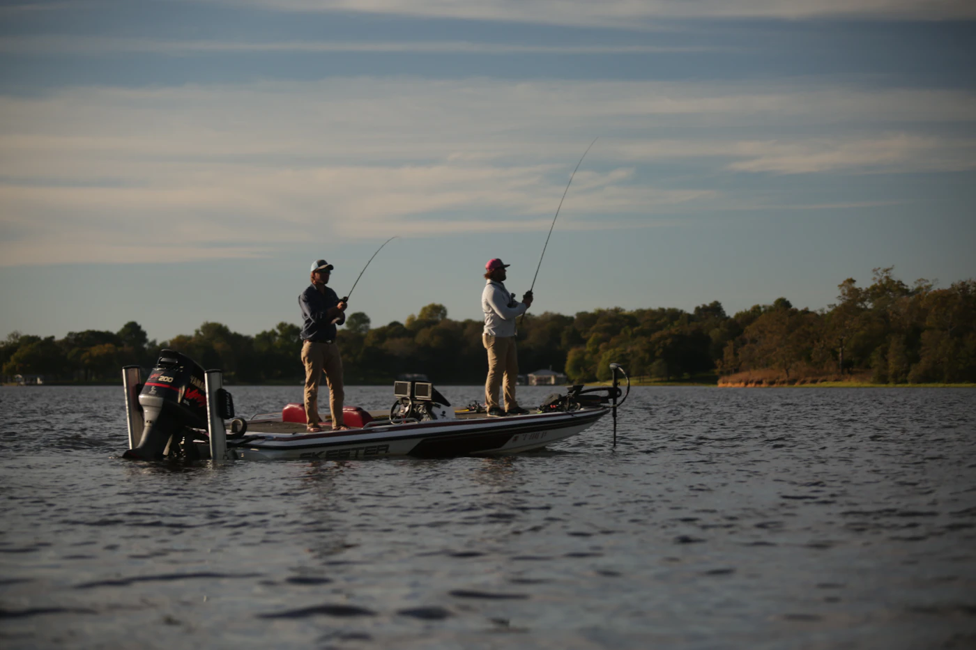 Two anglers on a bass boat at dawn