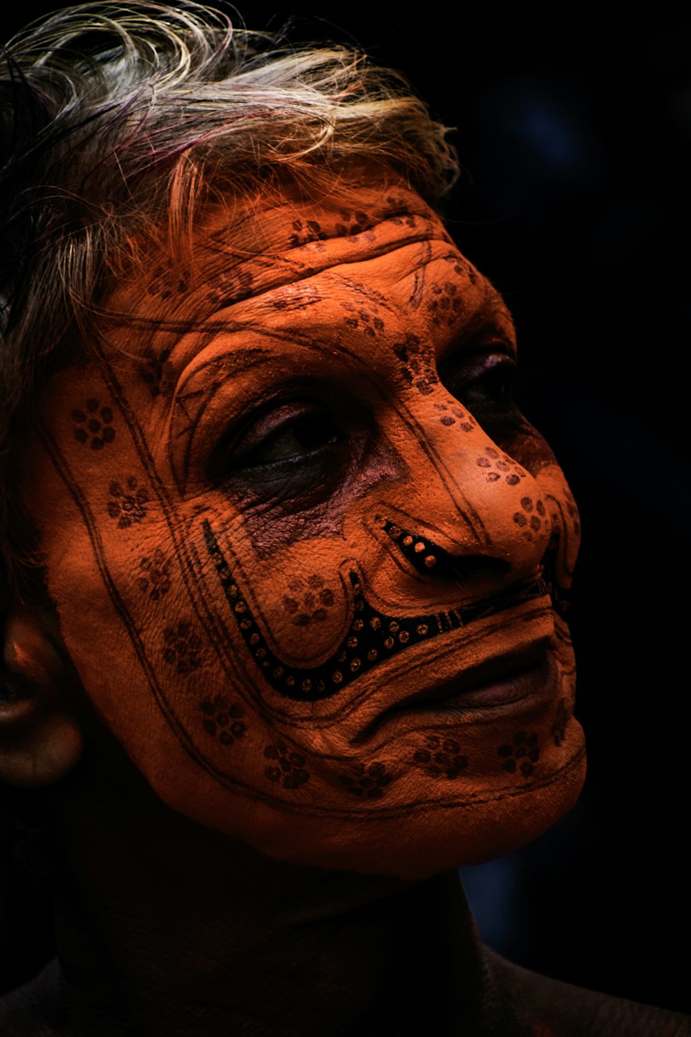 person with face tattoo in close-up shot