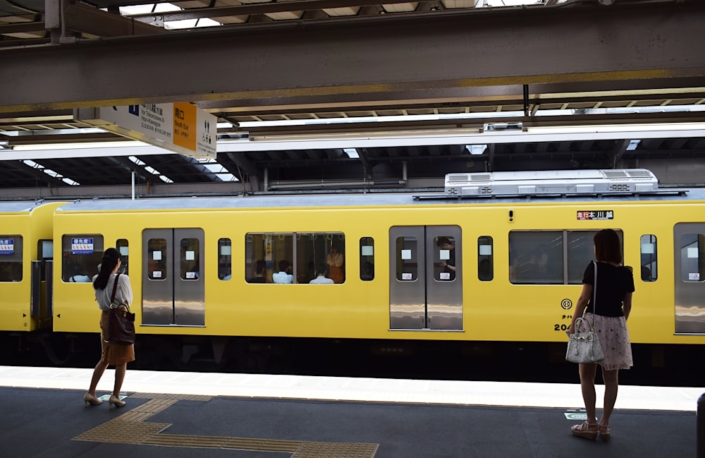 women in front of train